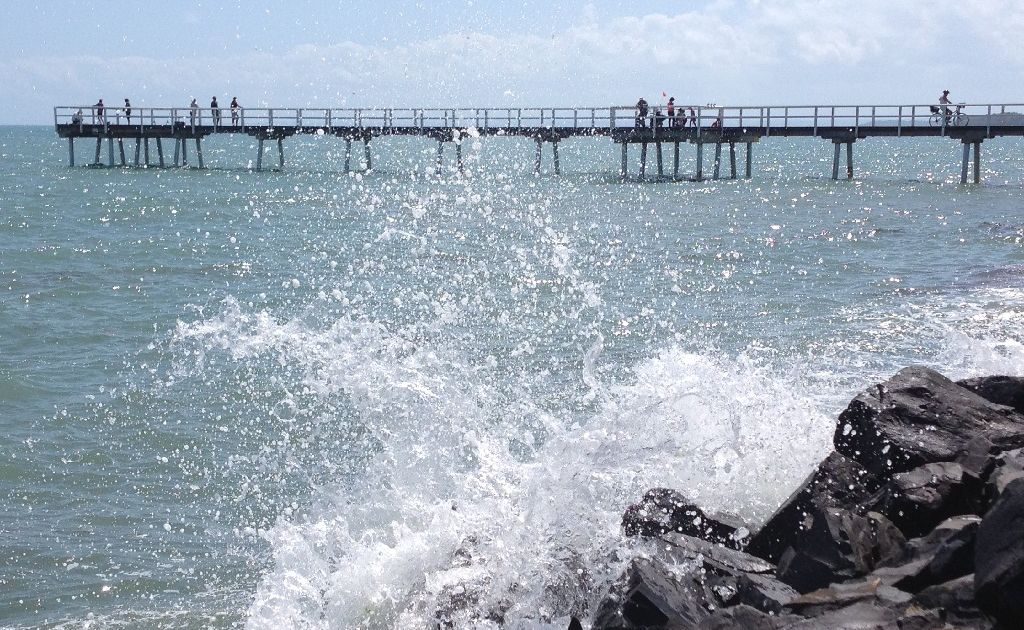 Waves crash onto rocks near the Scarness Pier during the king tide. Waves crash onto rocks near the Scarness Pier during the king tide.