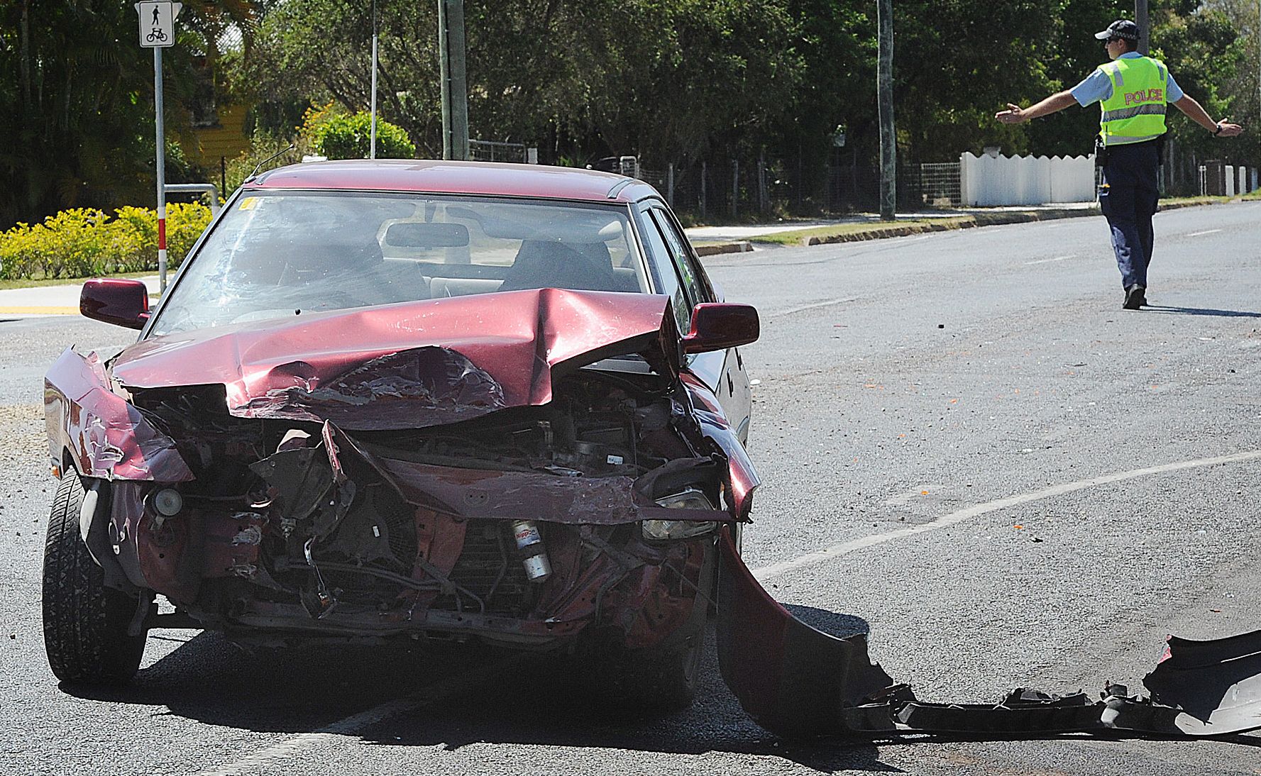 A police officer directs traffic after a crash between a car and a landscaping truck at the corner of Alice and Morning Sts in Maryborough. A police officer directs traffic after a crash between a car and a landscaping truck at the corner of Alice and Morning Sts in Maryborough.
