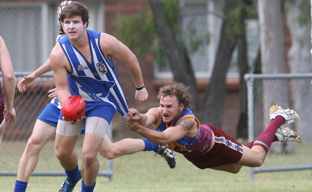 Brothers Matthew Pollock and Glenmore Brad Jenkinson in the AFL game at Stenlake Park. Photo Chris Ison / The Morning Bulletin. Brothers Matthew Pollock and Glenmore Brad Jenkinson in the AFL game at Stenlake Park. Photo Chris Ison / The Morning Bulletin.