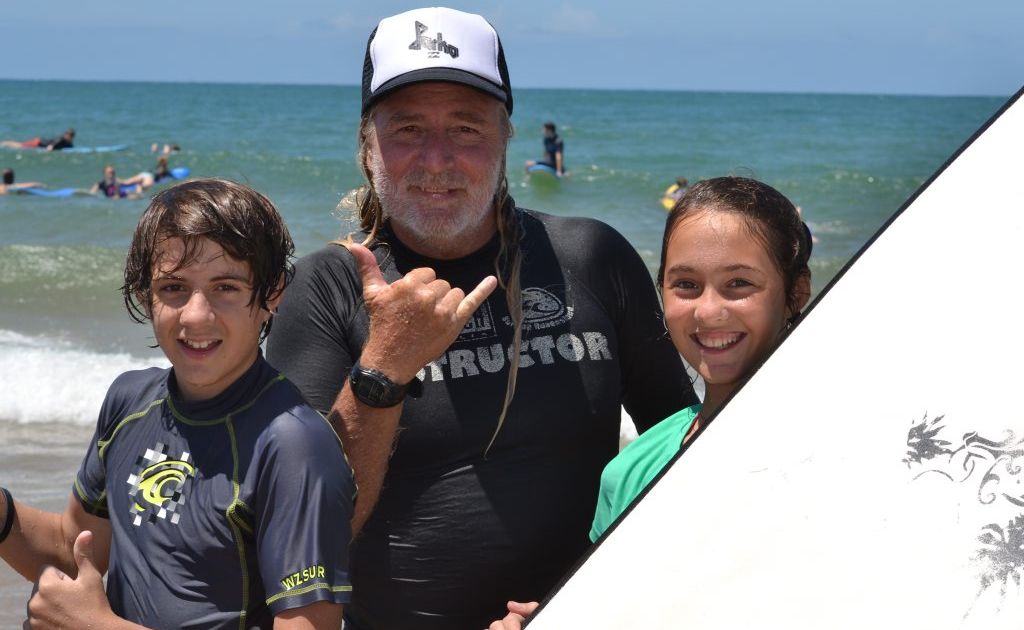 SUNNY DAY: Reef2Beach Surf School's Wayne 'Grom' Mellick with SUNfest kids Callum Dominguez and Matilda Moore at Agnes Water yesterday. SUNNY DAY: Reef2Beach Surf School's Wayne 'Grom' Mellick with SUNfest kids Callum Dominguez and Matilda Moore at Agnes Water yesterday.
