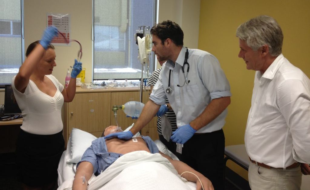 Interns Nicky Poole and Angus McNally in simulation training while MP Geoff Provest looks on. Photo: Luke Mortimer Interns Nicky Poole and Angus McNally in simulation training while MP Geoff Provest looks on. Photo: Luke Mortimer