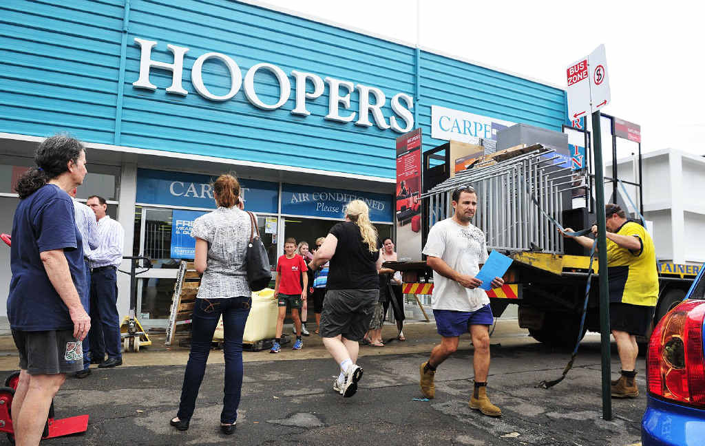 CHIPPING IN: A team of volunteers helped clear Hoopers Carpet One before flood waters entered yesterday. CHIPPING IN: A team of volunteers helped clear Hoopers Carpet One before flood waters entered yesterday.