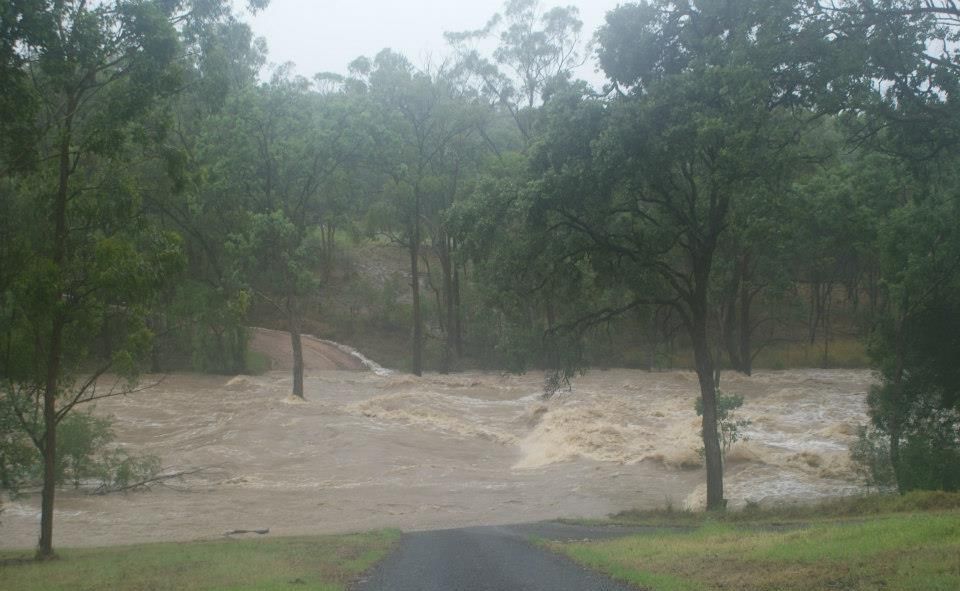 Floodwaters rage over Dingo Mountain Road near Crows Nest. Floodwaters rage over Dingo Mountain Road near Crows Nest.