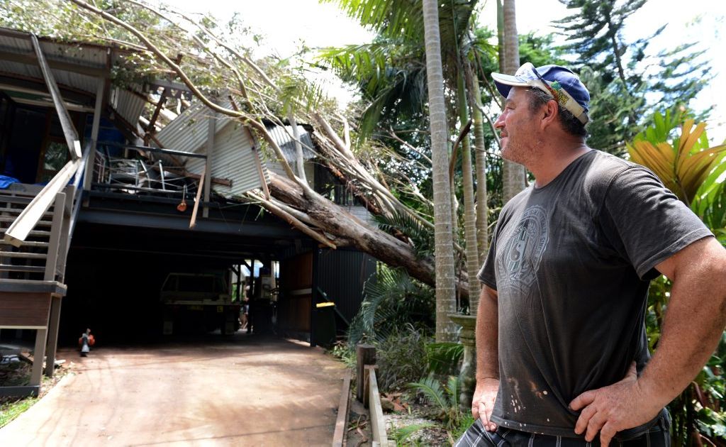 Warren Higgins with his house, which copped a tree through the roof this week. Warren Higgins with his house, which copped a tree through the roof this week.