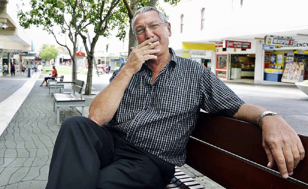 LAST GASP: Cr Charlie Pisasale enjoys a final cigarette in the Ipswich Mall yesterday. LAST GASP: Cr Charlie Pisasale enjoys a final cigarette in the Ipswich Mall yesterday.
