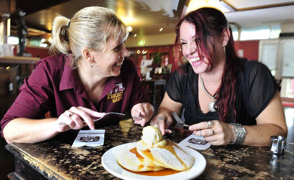 GIVING A TOSS: Pancake Manor Ipswich manager Joanne Harbort (left) and Ipswich Women’s Shelter support worker Michelle tuck into lunch. GIVING A TOSS: Pancake Manor Ipswich manager Joanne Harbort (left) and Ipswich Women’s Shelter support worker Michelle tuck into lunch.
