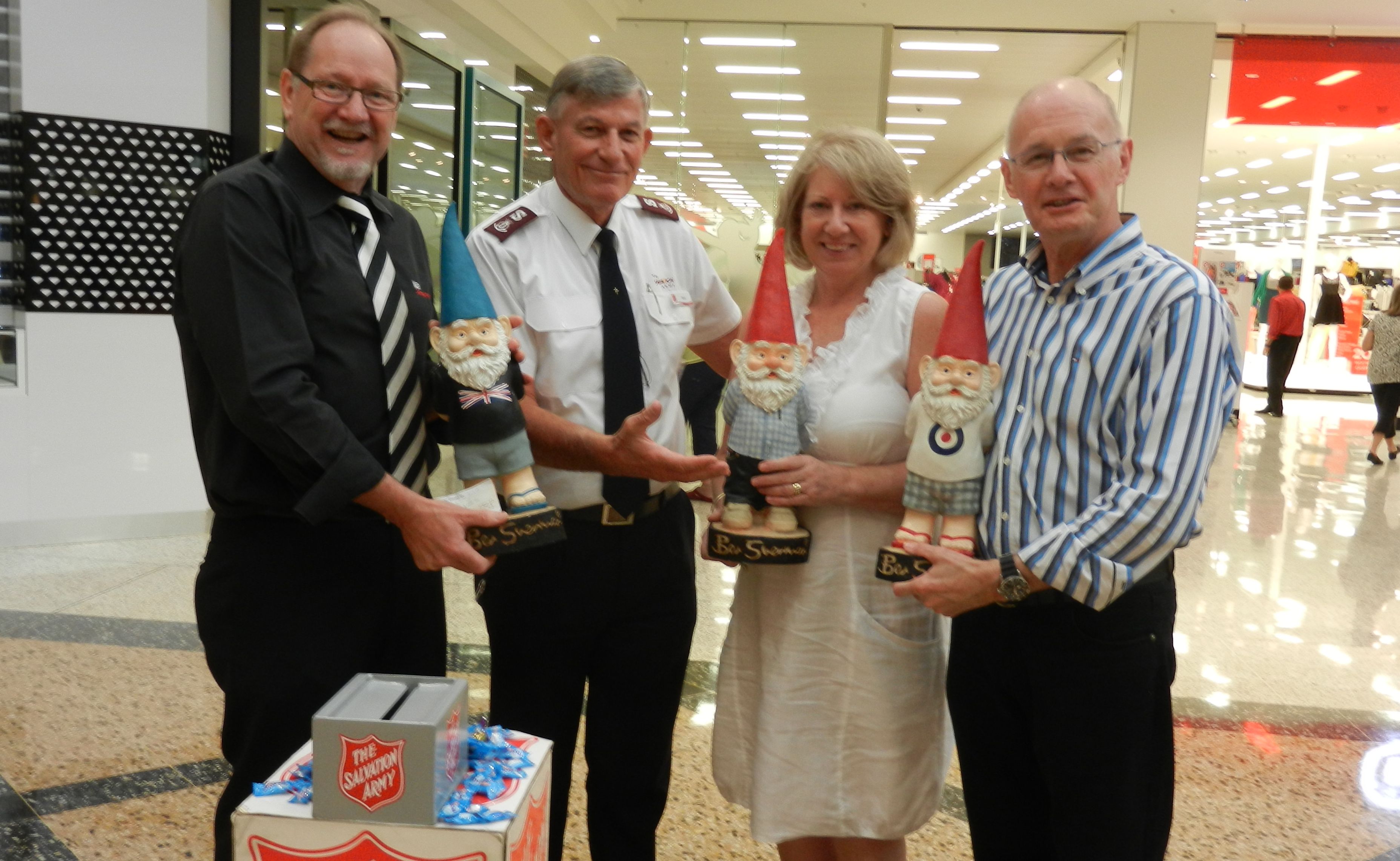 Chris Worboys (left) hands the cheque to Major Steve Metcher after Sharon and John Shaw bid farewell to their gnomes. Chris Worboys (left) hands the cheque to Major Steve Metcher after Sharon and John Shaw bid farewell to their gnomes.