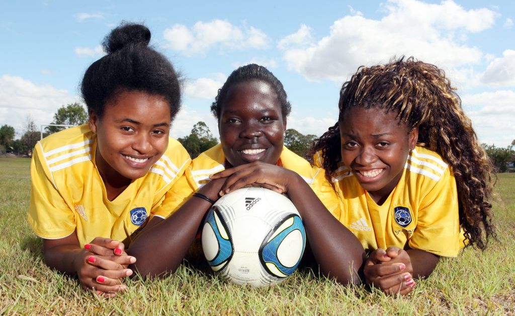 Logan Metro football club is helping players from disadvantaged countries. Pictured is Ariane Uwimana, Grace Edward and Martiae Mpungu. Photo: Inga Williams / The Reporter Logan Metro football club is helping players from disadvantaged countries. Pictured is Ariane Uwimana, Grace Edward and Martiae Mpungu. Photo: Inga Williams / The Reporter