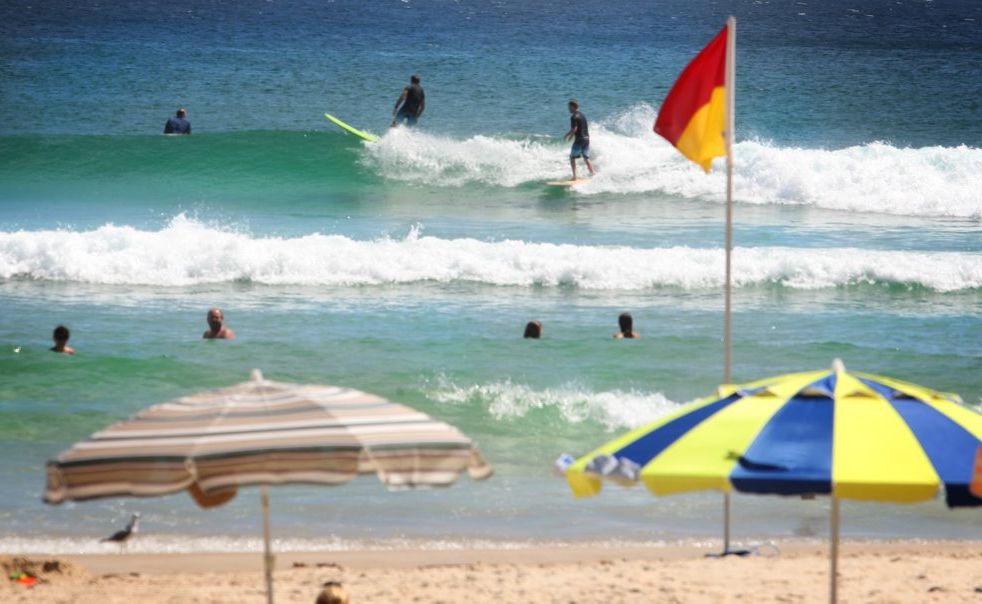 Surfers in the flags at Rainbow Bay in Coolangatta. Surfers in the flags at Rainbow Bay in Coolangatta.