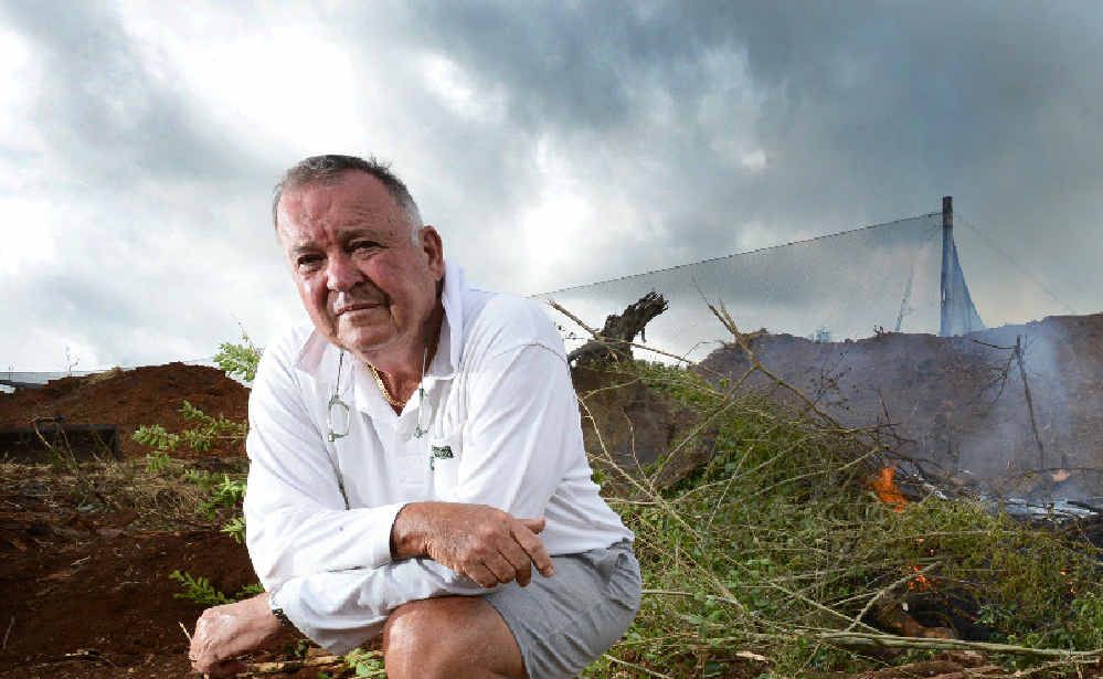 NO OPTION: Bangalow farmer Ray Hick kneels next to his burning fruit trees that he is destroying after the Federal Govt introduced a ban on chemicals to control fruit fly. NO OPTION: Bangalow farmer Ray Hick kneels next to his burning fruit trees that he is destroying after the Federal Govt introduced a ban on chemicals to control fruit fly.