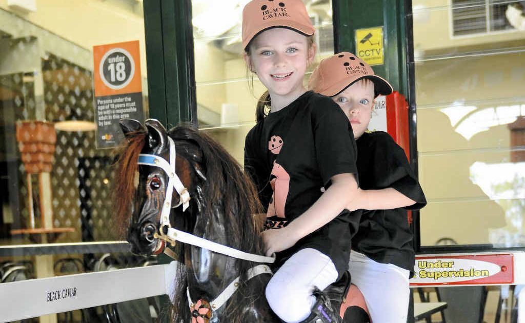 THE FAVOURITE: Hand carved by Greg Ryan from local silky oak timber, this rocking horse named Black Caviar was ridden by local girls Shani and Elsie Firth at Roche’s Hotel.Photo Debrah Novak THE FAVOURITE: Hand carved by Greg Ryan from local silky oak timber, this rocking horse named Black Caviar was ridden by local girls Shani and Elsie Firth at Roche’s Hotel.Photo Debrah Novak