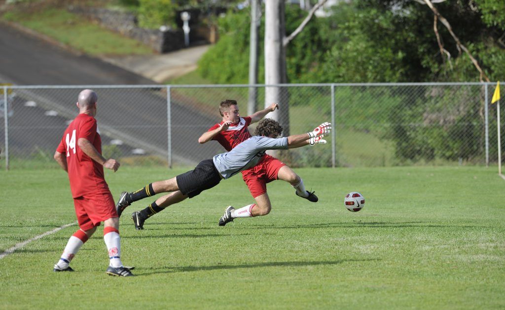 Hornets gola keeper Thomas Eyears and Workers player Matt Fitness clash in the reserve grade match of the 2012 Corey New Cup. Hornets gola keeper Thomas Eyears and Workers player Matt Fitness clash in the reserve grade match of the 2012 Corey New Cup.