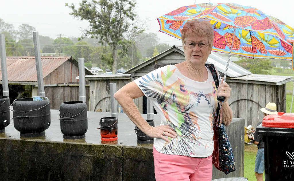 Wendy Smythe was taking cover from the rain at the official opening of the Lawrence Museum’s blacksmith’s hut on Saturday. Photo: Debrah Novak Wendy Smythe was taking cover from the rain at the official opening of the Lawrence Museum’s blacksmith’s hut on Saturday. Photo: Debrah Novak