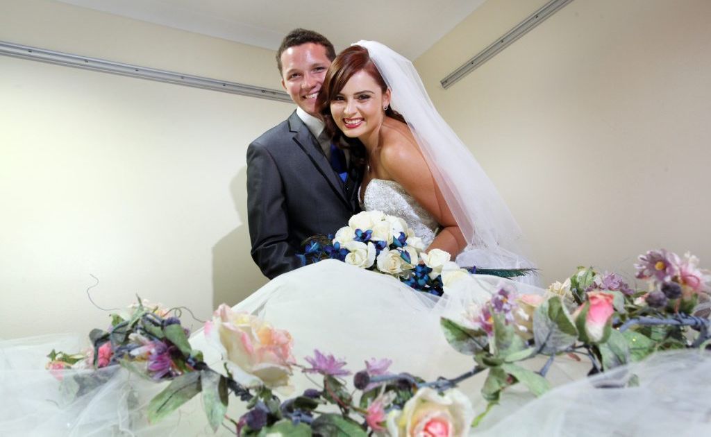 Renae Grinlaubs and Scott Knight getting ready for the Logan East Community Neighbourhod's wedding expo. Photo: Inga Williams / The Reporter Renae Grinlaubs and Scott Knight getting ready for the Logan East Community Neighbourhod's wedding expo. Photo: Inga Williams / The Reporter