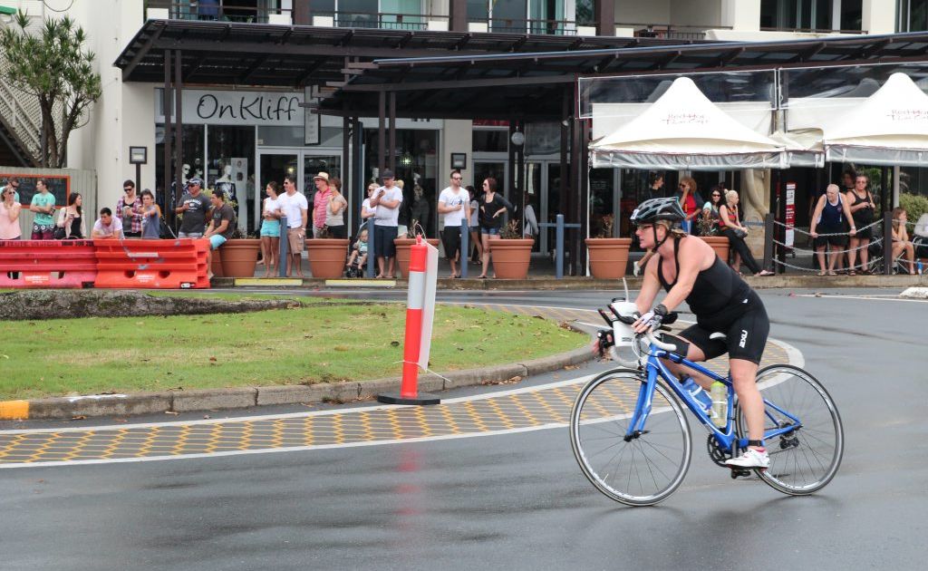 Spectators watch as Kingscliff Triathlon competitors ride past. Spectators watch as Kingscliff Triathlon competitors ride past.
