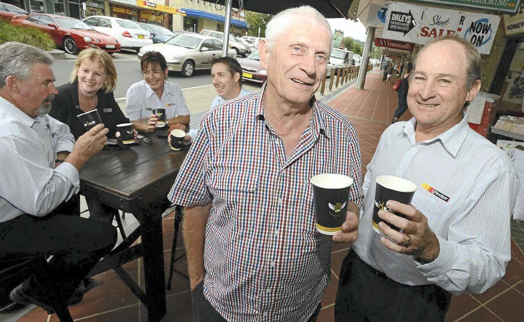 ESPRESSO: John Rees from Blueys Cafe, front left, and Paul Deegan from LJ Hooker Lismore, right, join staff from LJ Hooker in promoting the suspended coffee phenomenon. ESPRESSO: John Rees from Blueys Cafe, front left, and Paul Deegan from LJ Hooker Lismore, right, join staff from LJ Hooker in promoting the suspended coffee phenomenon.
