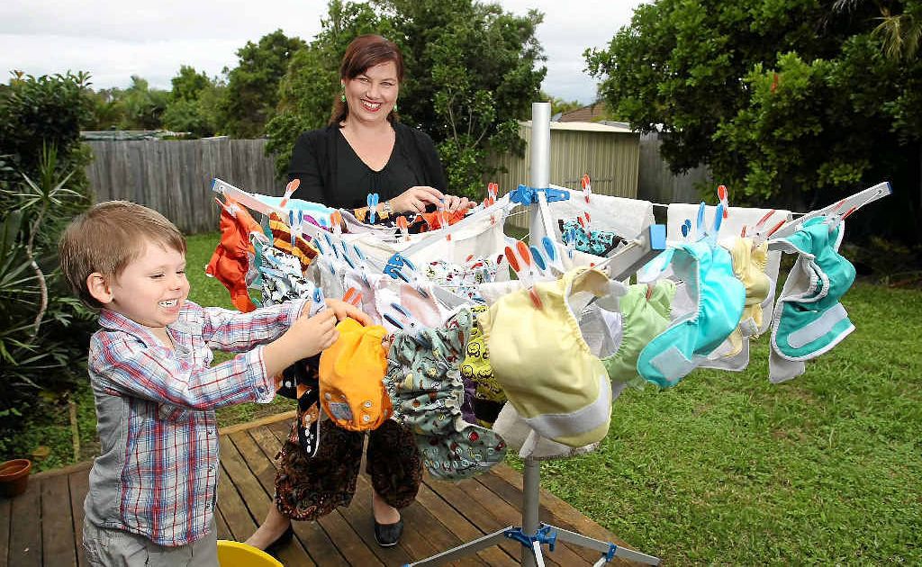 Archer Earl, 3, helps his mum Carly Earl hang cloth nappies on the clothesline. These reusable nappies save on landfill space. Archer Earl, 3, helps his mum Carly Earl hang cloth nappies on the clothesline. These reusable nappies save on landfill space.