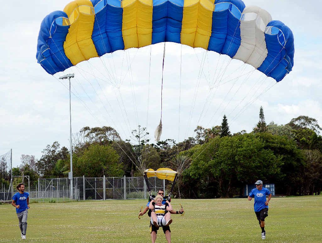 HAPPY LANDING: Janelle Ragen reaches land after tieing the knot at 14,000 feet. HAPPY LANDING: Janelle Ragen reaches land after tieing the knot at 14,000 feet.