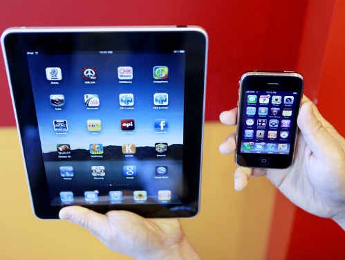 The iPad (left) features a much larger screen compared to the iPhone. The iPad (left) features a much larger screen compared to the iPhone.
