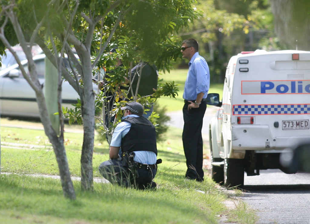 Police officers surround a Halligan St house during an eight-hour siege on Good Friday. Police officers surround a Halligan St house during an eight-hour siege on Good Friday.