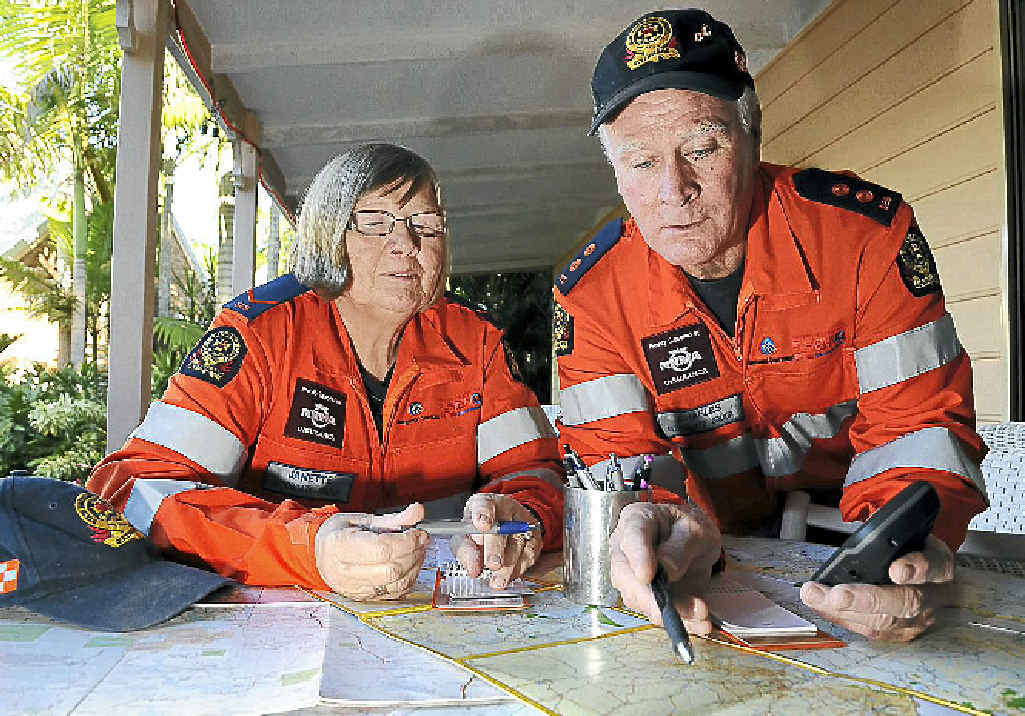 SES volunteers Jannette and Charles Elson prepare for a missing persons search exercise using maps and GPS technology. SES volunteers Jannette and Charles Elson prepare for a missing persons search exercise using maps and GPS technology.