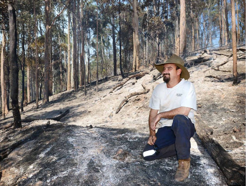 Mark Grennan on his burnt property at Goomboorian yesterday. Mark Grennan on his burnt property at Goomboorian yesterday.