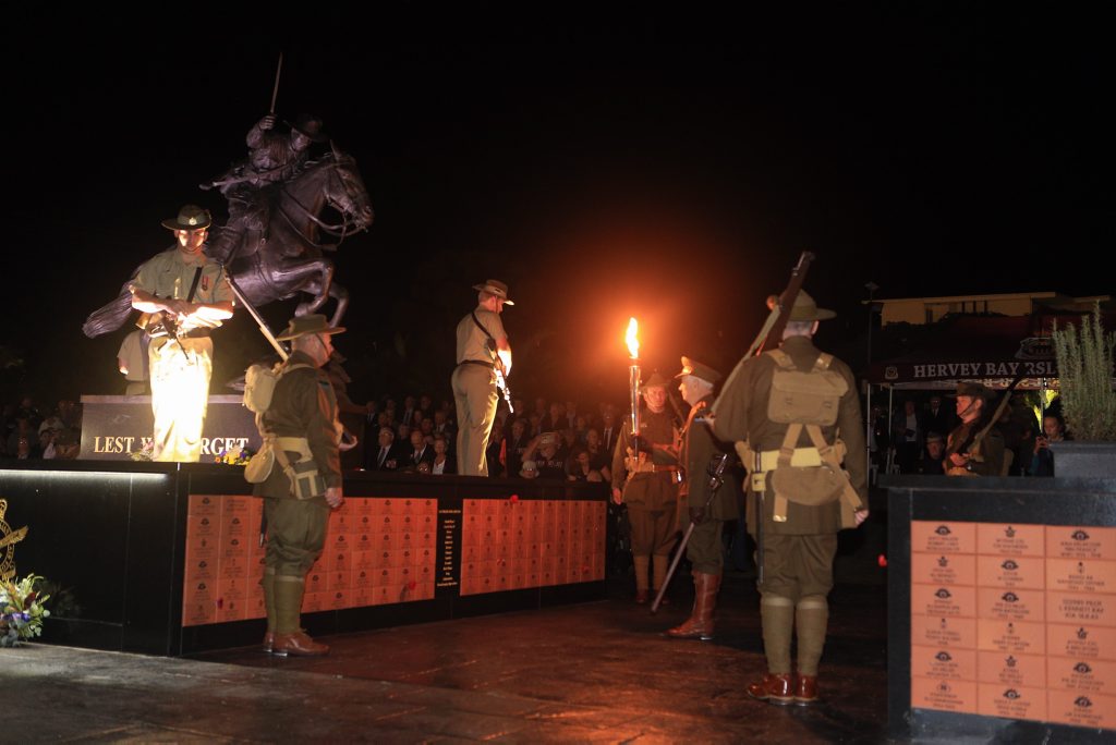 Jim Wilson and the 9th Battalion reenactment group present the revered, Anzac Flame at the dawn service in Hervey Bay's Freedom Park for the 2015 100th year Anzac commemoration. Photo: Brendan Bufi / Fraser Coast Chronicle Jim Wilson and the 9th Battalion reenactment group present the revered, Anzac Flame at the dawn service in Hervey Bay's Freedom Park for the 2015 100th year Anzac commemoration. Photo: Brendan Bufi / Fraser Coast Chronicle