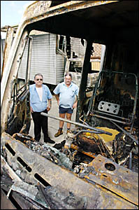 TRUCKS TORCHED: David Cupitt, left, and Kevin Heeb with two of the furniture trucks which were torched at Ballina on Saturday. TRUCKS TORCHED: David Cupitt, left, and Kevin Heeb with two of the furniture trucks which were torched at Ballina on Saturday.