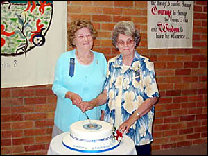 Gwen Stanford and Elnor Bostock cut the birthday cake Gwen Stanford and Elnor Bostock cut the birthday cake