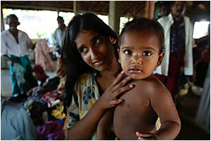A Sri Lankan mother and her baby wait for help A Sri Lankan mother and her baby wait for help