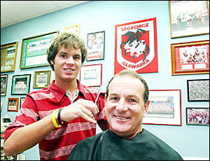 TWEED City barber and rugby league afficionado Garry ?Crinkles? Hattley in the chair with his apprentice barber son, Cameron. TWEED City barber and rugby league afficionado Garry ?Crinkles? Hattley in the chair with his apprentice barber son, Cameron.