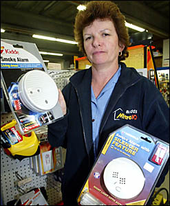 MURWILLUMBAH Mitre 10?s Julie Harper with a selection of smoke alarms which have been selling quickly this week following a rec MURWILLUMBAH Mitre 10?s Julie Harper with a selection of smoke alarms which have been selling quickly this week following a rec