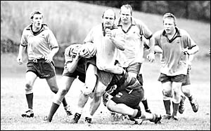 Southern Cross Uni?s Peter Murphy makes good ground, supported by Matt Anderson, left, Dave Hayter, right, and Adam Condon, far Southern Cross Uni?s Peter Murphy makes good ground, supported by Matt Anderson, left, Dave Hayter, right, and Adam Condon, far