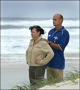CUDGEN Surf Life Saving Club members Chris Quinlan and Adam Mills survey the beach after helping rescue three people off south CUDGEN Surf Life Saving Club members Chris Quinlan and Adam Mills survey the beach after helping rescue three people off south