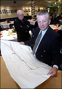 TWEED Chamber of Commerce president John Murray and RTA Community Liaison Group member Rod Bates (at rear) with a map showing t TWEED Chamber of Commerce president John Murray and RTA Community Liaison Group member Rod Bates (at rear) with a map showing t