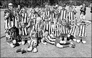 Members of the North Coffs under-12 junior AFLteam celebrate their grand final victoiry over Sawtell at the Showground on Sund Members of the North Coffs under-12 junior AFLteam celebrate their grand final victoiry over Sawtell at the Showground on Sund