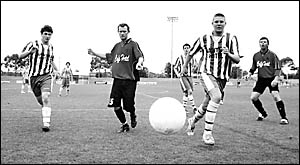 Who?s ball is it? Players from both teams chase hard to secure possession in the reserve grade men?s game. Who?s ball is it? Players from both teams chase hard to secure possession in the reserve grade men?s game.