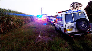 ROADSIDE COMMAND: Police and ambulance officers establish a command post at the intersection of Gallaghers Lane and the Pacific ROADSIDE COMMAND: Police and ambulance officers establish a command post at the intersection of Gallaghers Lane and the Pacific