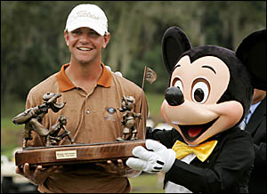 Lucas Glover holds the Funai Classic trophy with Mickey Mouse after winning the event with a birdie on the 18th hole. Glover wa Lucas Glover holds the Funai Classic trophy with Mickey Mouse after winning the event with a birdie on the 18th hole. Glover wa