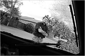 Warren inspects the most recent damage to his car Warren inspects the most recent damage to his car
