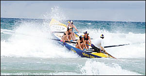 The South Curl Curl women?s crew crash through the wind-blown Park Beach surf. The South Curl Curl women?s crew crash through the wind-blown Park Beach surf.