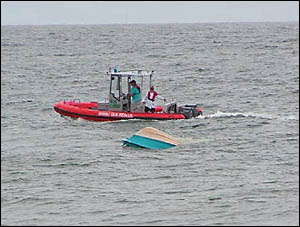 Members of the Wooli Volunteer Rescue Association tow the boat toward land. Members of the Wooli Volunteer Rescue Association tow the boat toward land.