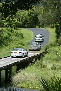 Car loads of detectives and uniformed police arrive at the Hare Krishna farm yesterday. Car loads of detectives and uniformed police arrive at the Hare Krishna farm yesterday.