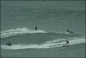 Surfers chase a wave at Kirra with the assistance of jetskis after the Quiksilver Pro was put on hold. Surfers chase a wave at Kirra with the assistance of jetskis after the Quiksilver Pro was put on hold.