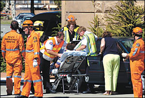 Emergency service workers attend to the driver of a Subaru Impreza after colliding with a bus on Saturday afternoon. Ph Emergency service workers attend to the driver of a Subaru Impreza after colliding with a bus on Saturday afternoon. Ph