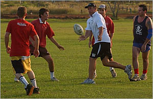 GOLD Coast Titans head coach John Cartwright, centre, gets involved in a South Grafton Rebels training session on Thursday nigh GOLD Coast Titans head coach John Cartwright, centre, gets involved in a South Grafton Rebels training session on Thursday nigh