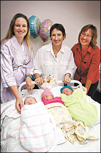 Natasha Atkin, Lorraine Goodrick and midwife Alison Moody admire Mrs Atkin?s new daughter and Mrs Goodrick?s twins, all born on Natasha Atkin, Lorraine Goodrick and midwife Alison Moody admire Mrs Atkin?s new daughter and Mrs Goodrick?s twins, all born on