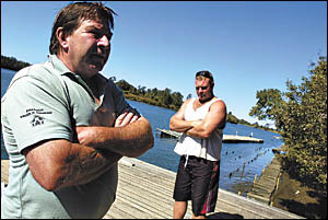 Mick Swanston, left, and Mark White at their oyster farm on the Bellinger Rvr Mick Swanston, left, and Mark White at their oyster farm on the Bellinger Rvr