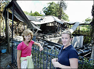 PAM Smith and Jo O?Connell, survey the burnt remains of what was only a few hours before the house that adjoined their propert PAM Smith and Jo O?Connell, survey the burnt remains of what was only a few hours before the house that adjoined their propert