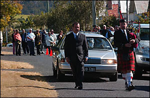 Funeral director John Baker and Maclean piper Alistair Wallace lead the procession from the St James Anglican Church, Maclean, Funeral director John Baker and Maclean piper Alistair Wallace lead the procession from the St James Anglican Church, Maclean,